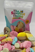 Colorful gummy candies in front of a 'The Swedest Thing' branded bag on a white background