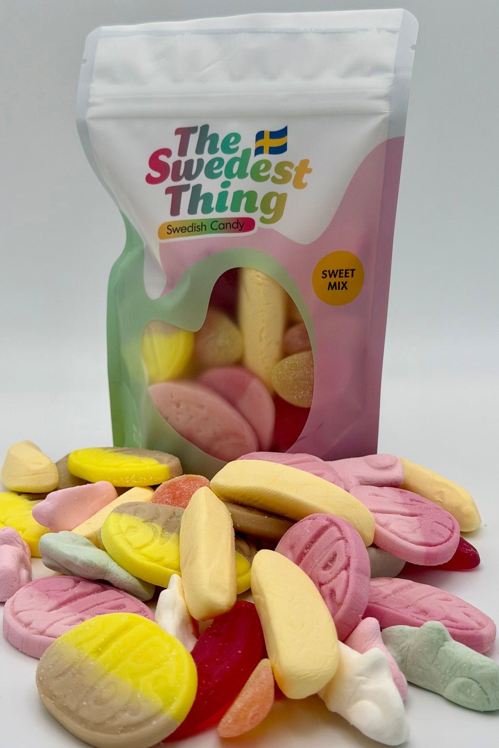 Colorful candy mix with a 'The Swedest Thing' branded bag on a white background