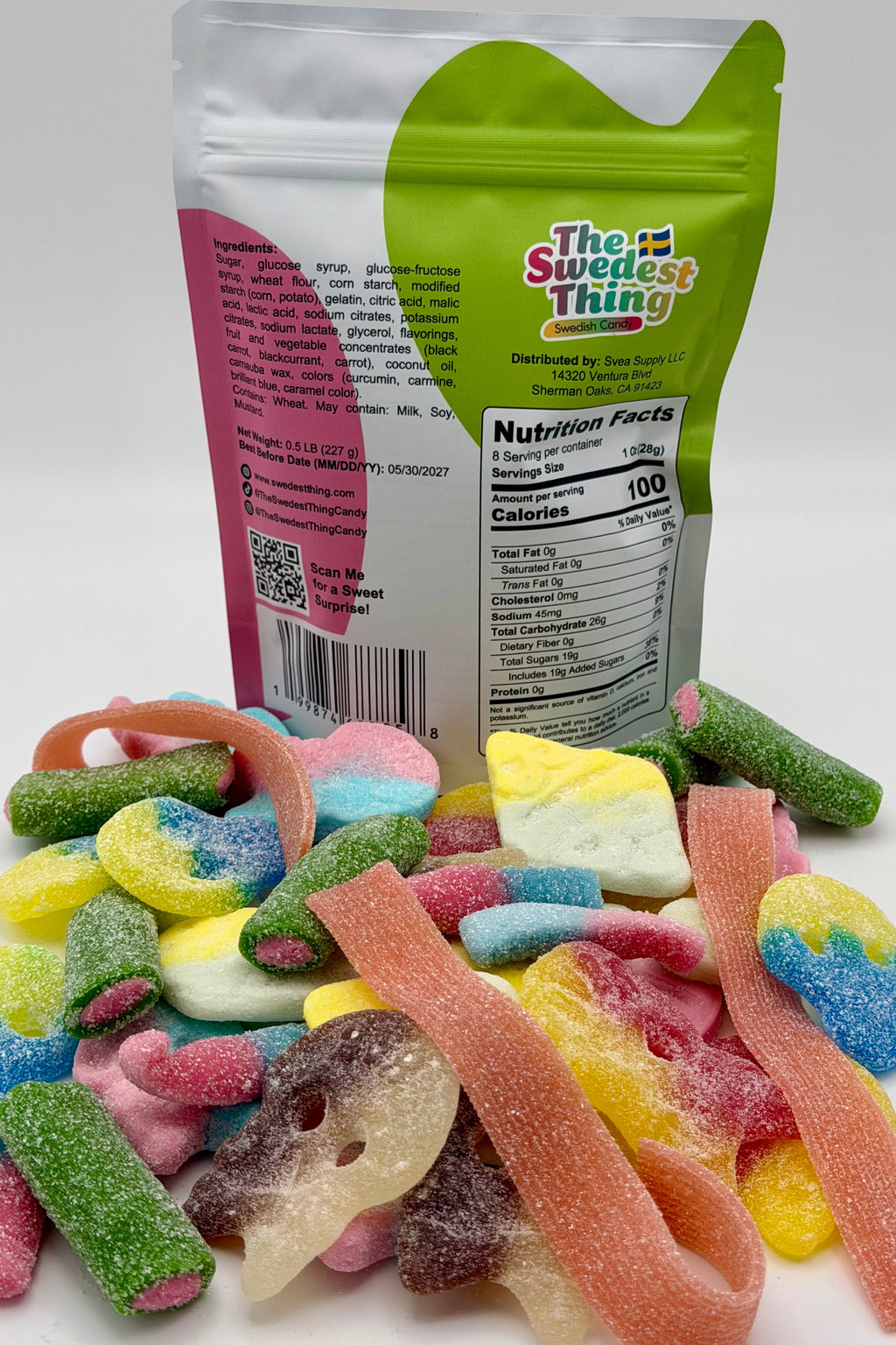 Colorful gummy candies in front of a 'The Swedest Thing' branded packaging on a white background