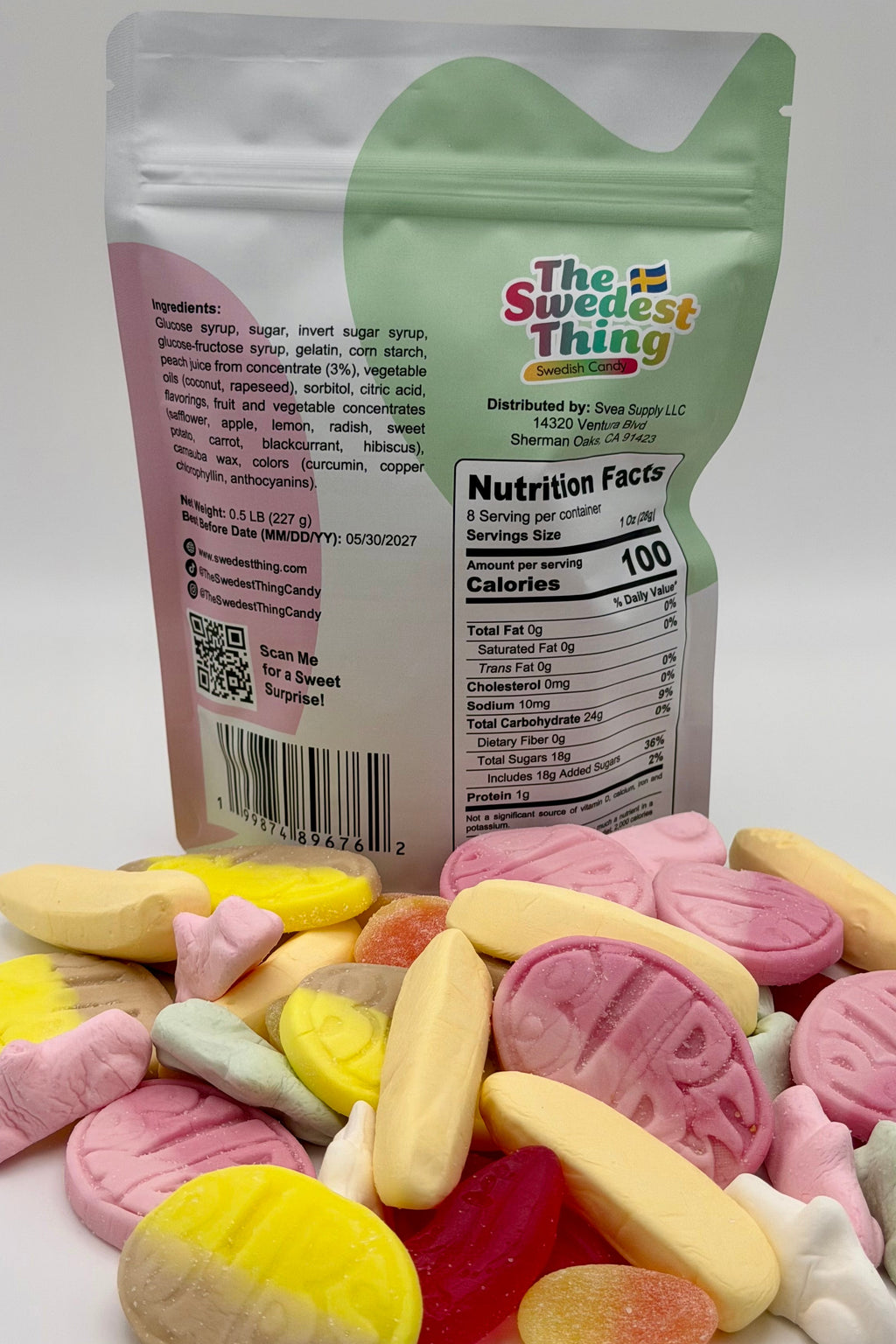 Colorful candy pieces in front of a 'The Swedest Thing' packaging on a white background